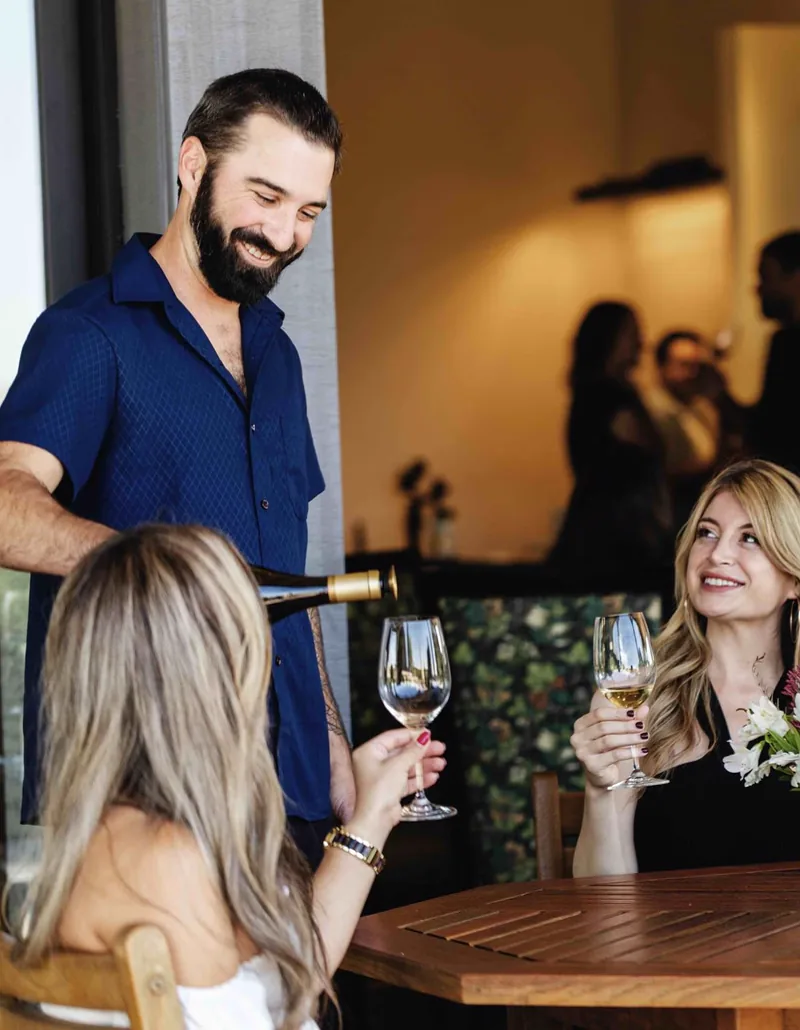 Professionals discussing wines in a California tasting room.
